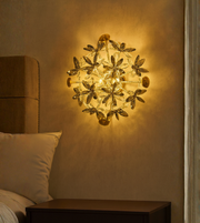 Florelux gold crystal wall light illuminating bedroom wall softly.