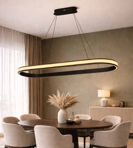 Modern black oval LED ring pendant light with warm white illuminated diffuser suspended above a contemporary dining table.