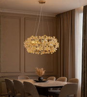 Florenza gold crystal floral chandelier glowing above elegant dining setup.