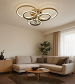 Velluno gold ceiling light adding artistic glow to soft neutral interior.