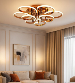 Aureon gold ring chandelier casting warm light over elegant modern interior.