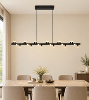 Modern black linear LED pendant chandelier with multiple warm white lights suspended above a luxury dining table.