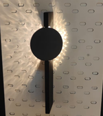 Daya Worldwide Lumina black and gold wall light mounted on a wall, showcasing modern design and elegant gold accents.