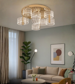 Layered acrylic chandelier with gold base lighting up a modern living room