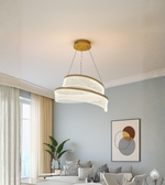 Modern curved LED chandelier with gold trim and wave acrylic panels