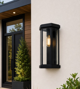 Modern black metal and glass outdoor wall light with decorative E27 bulb mounted on an exterior wall