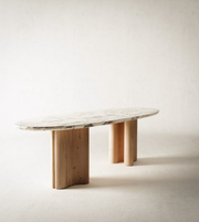 Sculpted marble and wood dining table with a modern design, featuring smooth surfaces and elegant craftsmanship by Daya Worldwide.