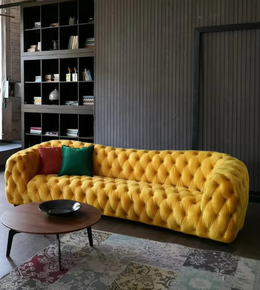 A modern Aurelia Curve sofa by Daya Worldwide with plush fabric and a sleek curved design, set in a stylish living room.