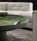Round green coffee table with a smooth surface and modern design, ideal for living room decor by Daya Worldwide.