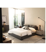 Elegant Noir Luxe upholstered bed in dark fabric with a padded headboard, showcasing modern bedroom furniture design.