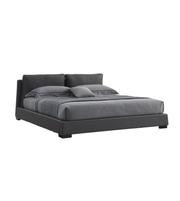 Noir Luxe upholstered bed with a padded headboard in a modern bedroom setting, featuring plush fabric and sleek design details.