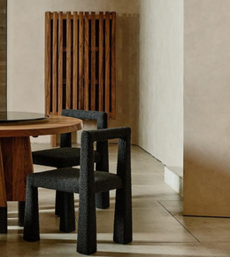 Modern textured dining chair with sleek design and wooden legs, perfect for contemporary dining rooms.