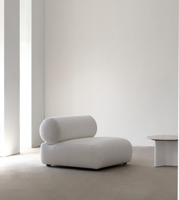 Daya Worldwide Nova lounge chair with a sleek modern design, featuring plush cushions and wooden legs in a contemporary living space.
