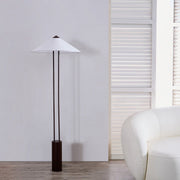 Elegant modern floor lamp placed beside sofa in neutral interior