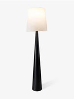 Modern black tapered floor lamp with white fabric shade on a white background