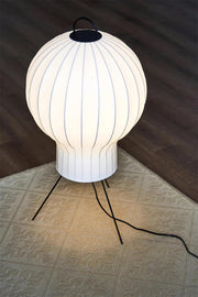 Close-up of ribbed paper lantern lamp shade with warm glow