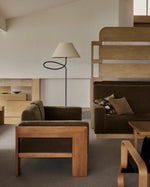 Minimal floor lamp paired with modern wooden furniture