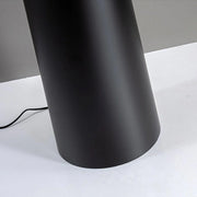 Close-up of matte black tapered base of modern floor lamp