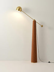 Minimalist floor lamp with gold finish arm and warm lighting