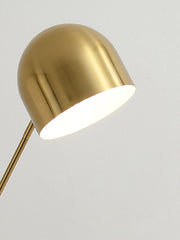 Close-up of brushed brass dome shade on modern floor lamp
