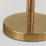 Round brass base of modern designer floor lamp