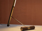Close-up of brass counterweight base of designer floor lamp