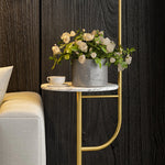 Close-up of marble side table attached to gold floor lamp