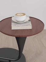 Close-up of round wooden side table attached to floor lamp