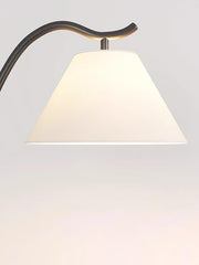 Fabric lampshade detail of modern arc floor lamp with warm lighting