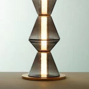 Close-up of textured metal finish on sculptural floor lamp base