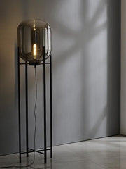 Minimalist floor lamp with smoked glass shade in modern interior