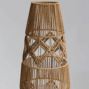 Tall woven floor lamp with geometric pattern and soft warm lighting