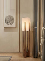 Modern wooden floor lamp illuminating a living room interior