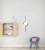 Designer round wall light with vertical rod in minimalist living room