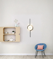 Designer round wall light with vertical rod in minimalist living room