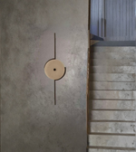 Sculptural disc wall lamp emitting soft warm ambient glow