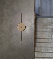 Sculptural disc wall lamp emitting soft warm ambient glow