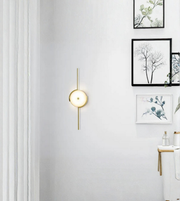 Designer round wall light with vertical rod in minimalist living room