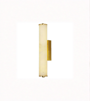 Wall-mounted light fixture with gold finish and white shade on a white background