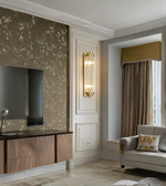 Modern living room with a sofa, wall-mounted television, and decorative elements.