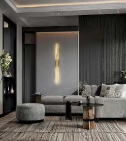 Vertical gold wall lamp installed in modern living room