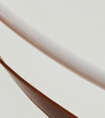 Close-up of a book with a rose gold spine on a white background