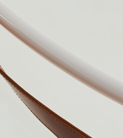 Close-up of a book with a rose gold spine on a white background