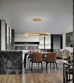 Modern kitchen and dining area with a pendant light fixture.