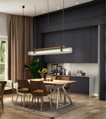 Modern kitchen with pendant light fixture, dining table, and chairs.