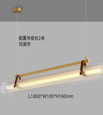 Modern pendant light with gold fixture on a gray background