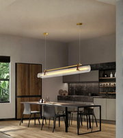 Modern kitchen with pendant lights and a dining table.