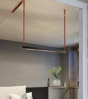 Modern pendant light hanging in a room with a neutral color palette.
