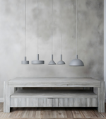 Wooden TV stand with four hanging pendant lights against a gray wall.
