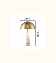 Gold table lamp with measurements on a white background